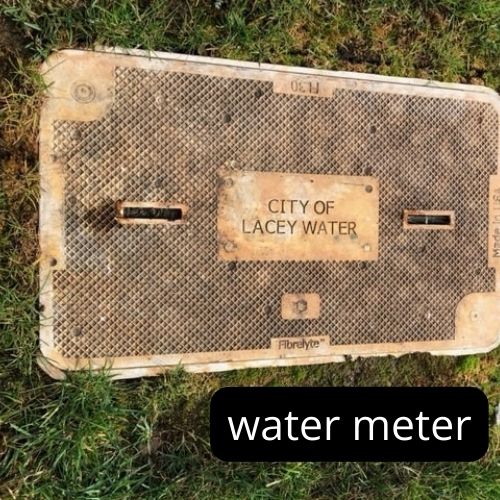 rectangular water meter cover with City of Lacey Water lettering